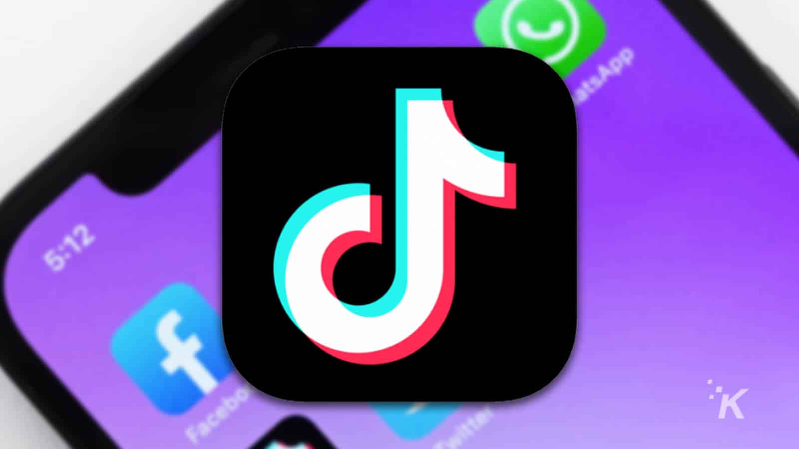 背景にぼやけたスマートフォンを持つtiktokのロゴ