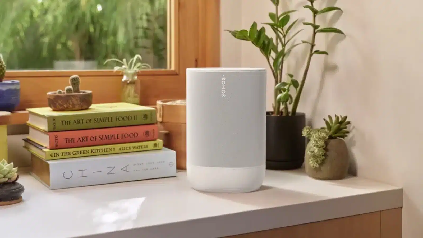sonos move 2: sonic leap forward atau sekadar speaker portabel lainnya? 9 Sonos move 2 speaker in white on a countertop surrounded by books and plants