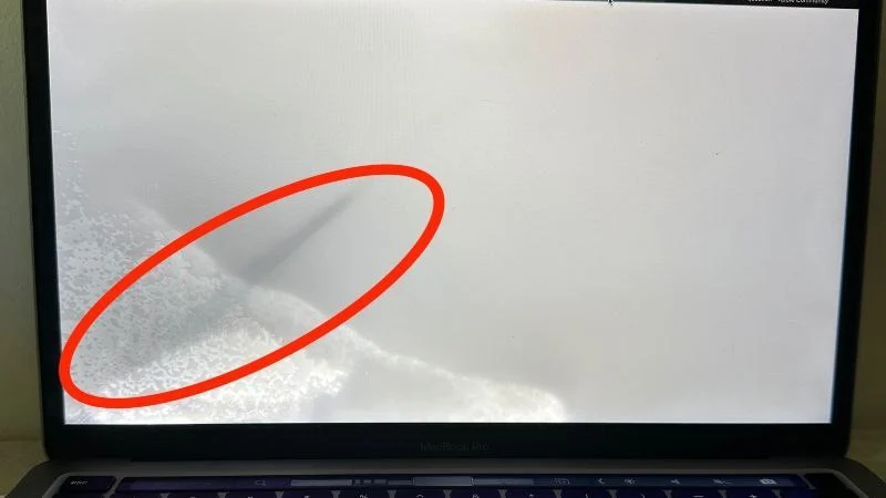 macbook display with signs of water damage