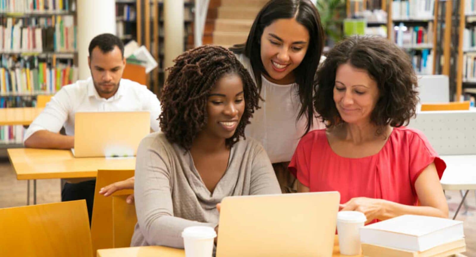 Essayai students in library.