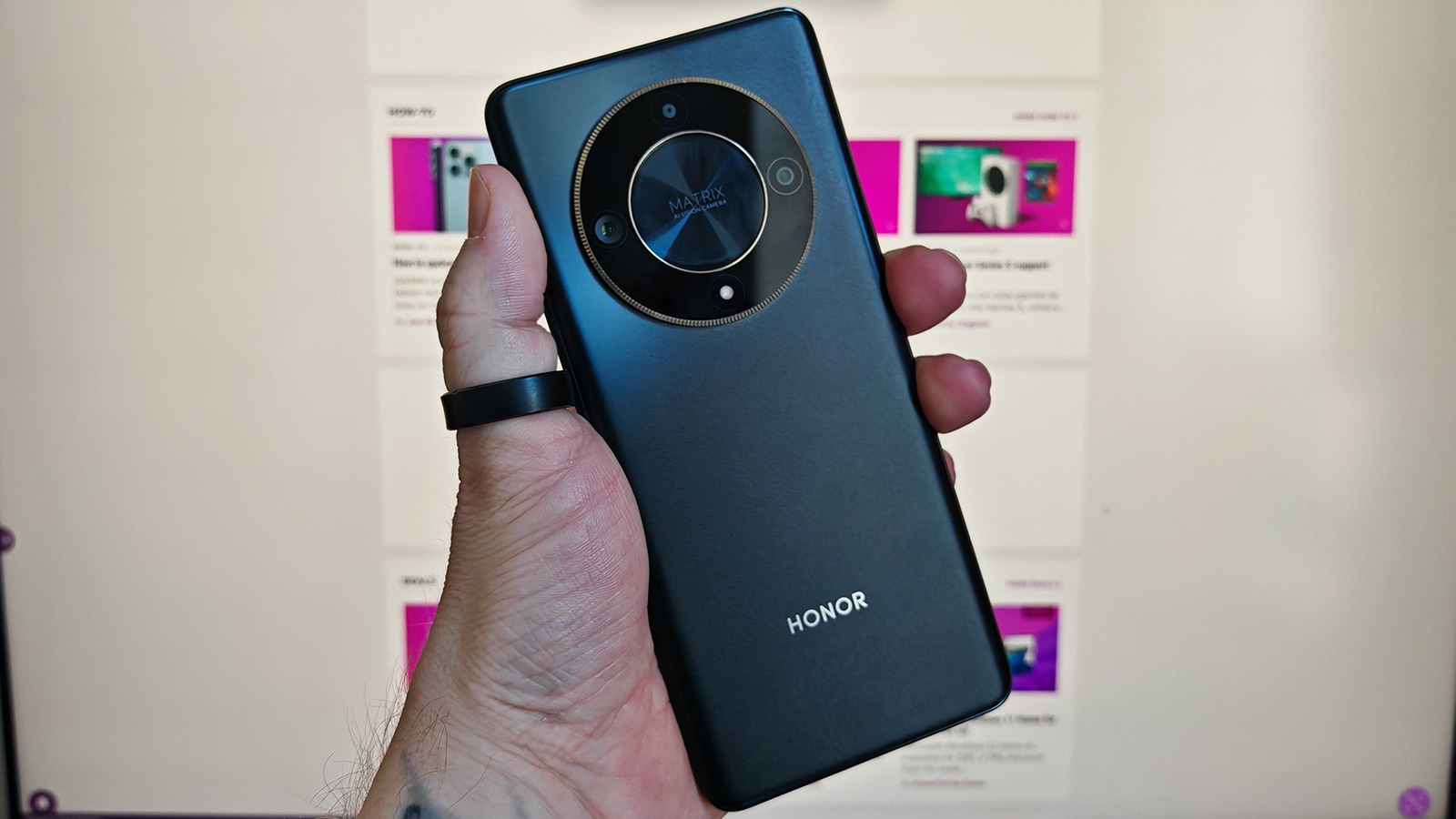 Holding honor magic6 lite in hand showing rear camera