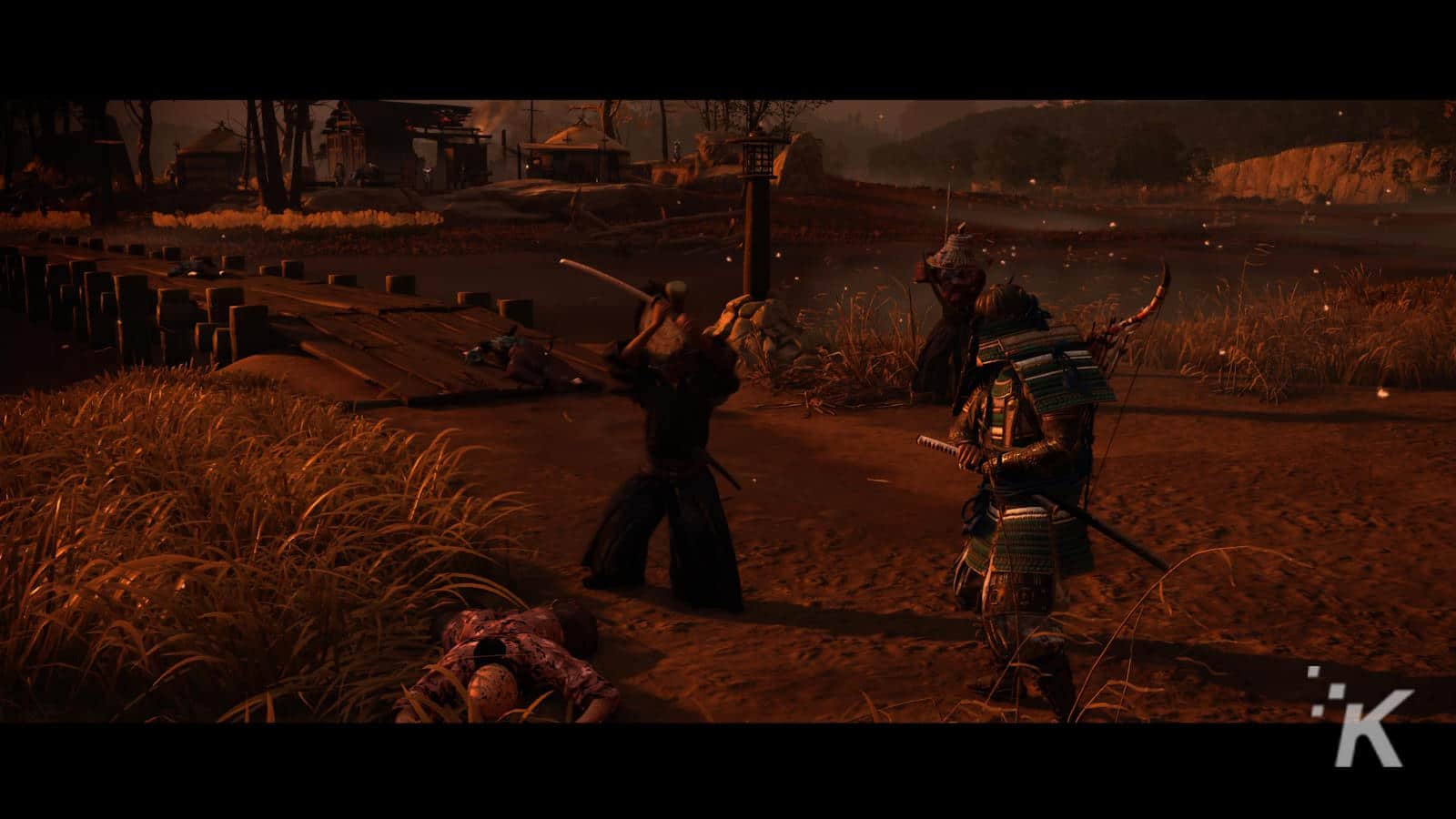 Two samurai warriors engaged in combat with swords on a dimly lit battlefield, surrounded by tall grass and traditional japanese structures, with a body lying on the ground and a calm river in the background.