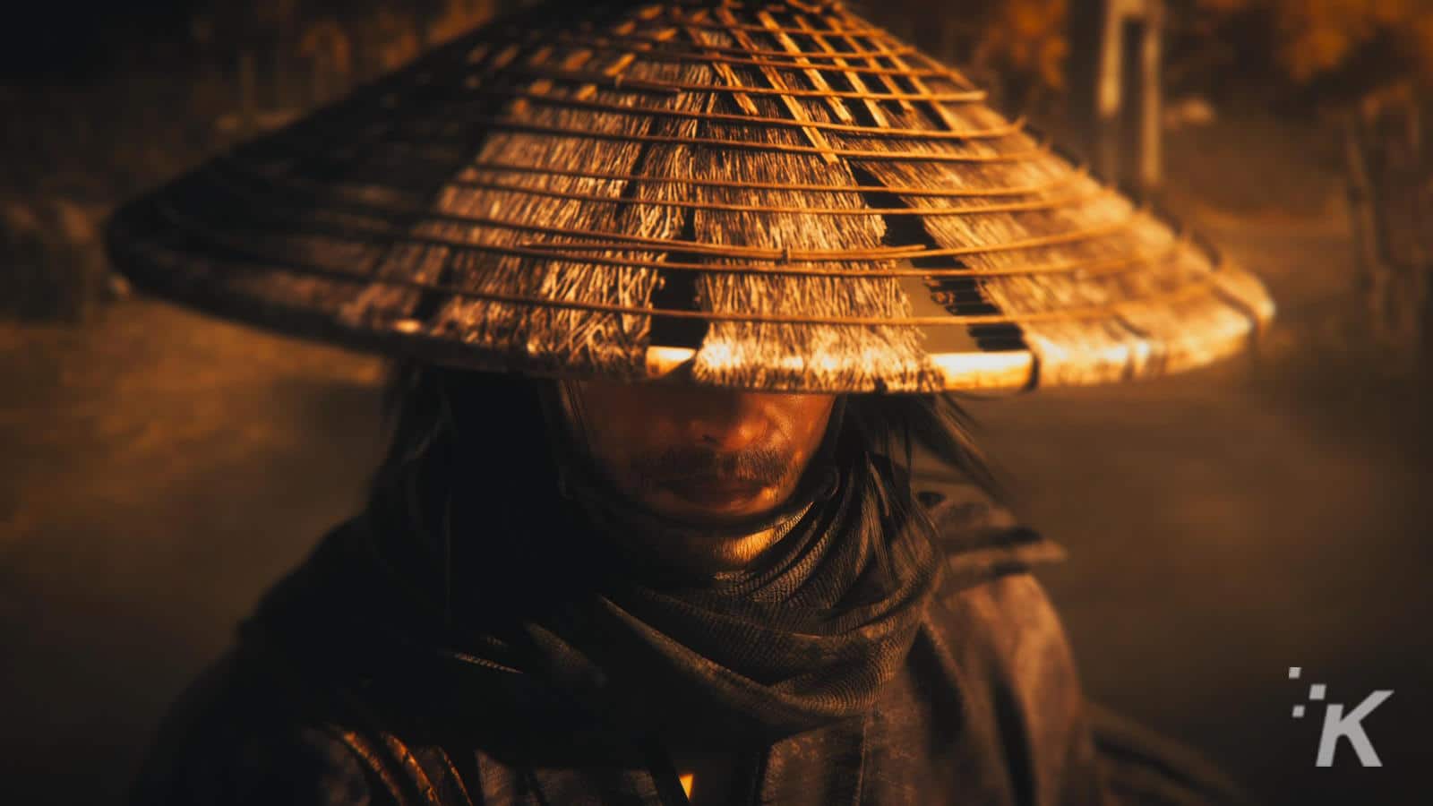 A person wearing a traditional conical asian hat, partly obscuring their face, set against a warm, soft-focus background.