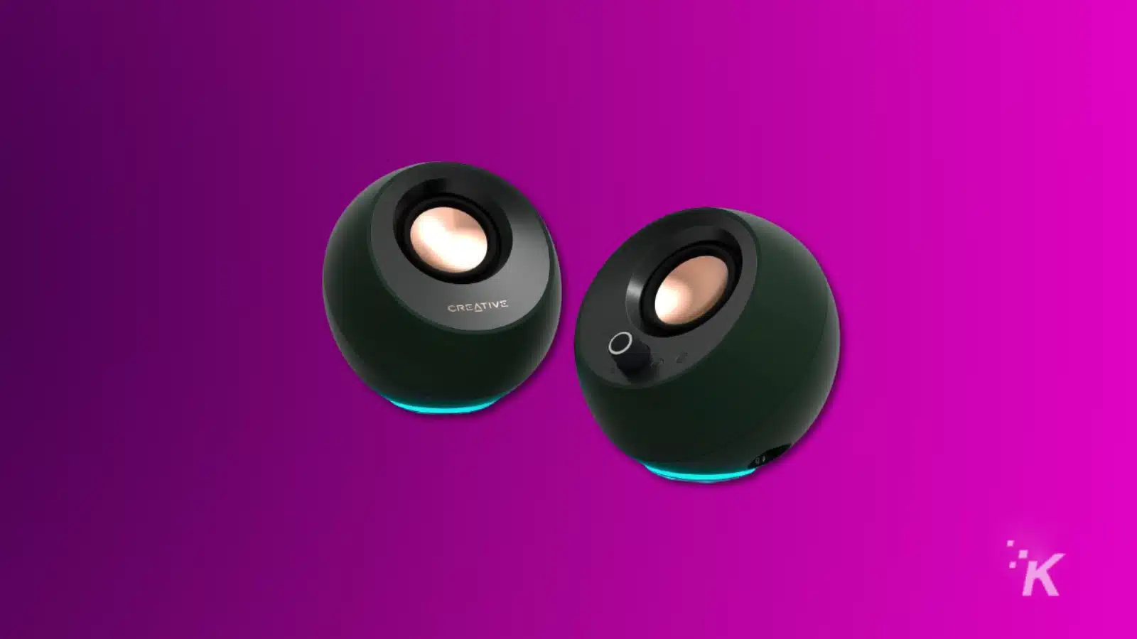 Render of creative pebble pro computer speakers on a purple background
