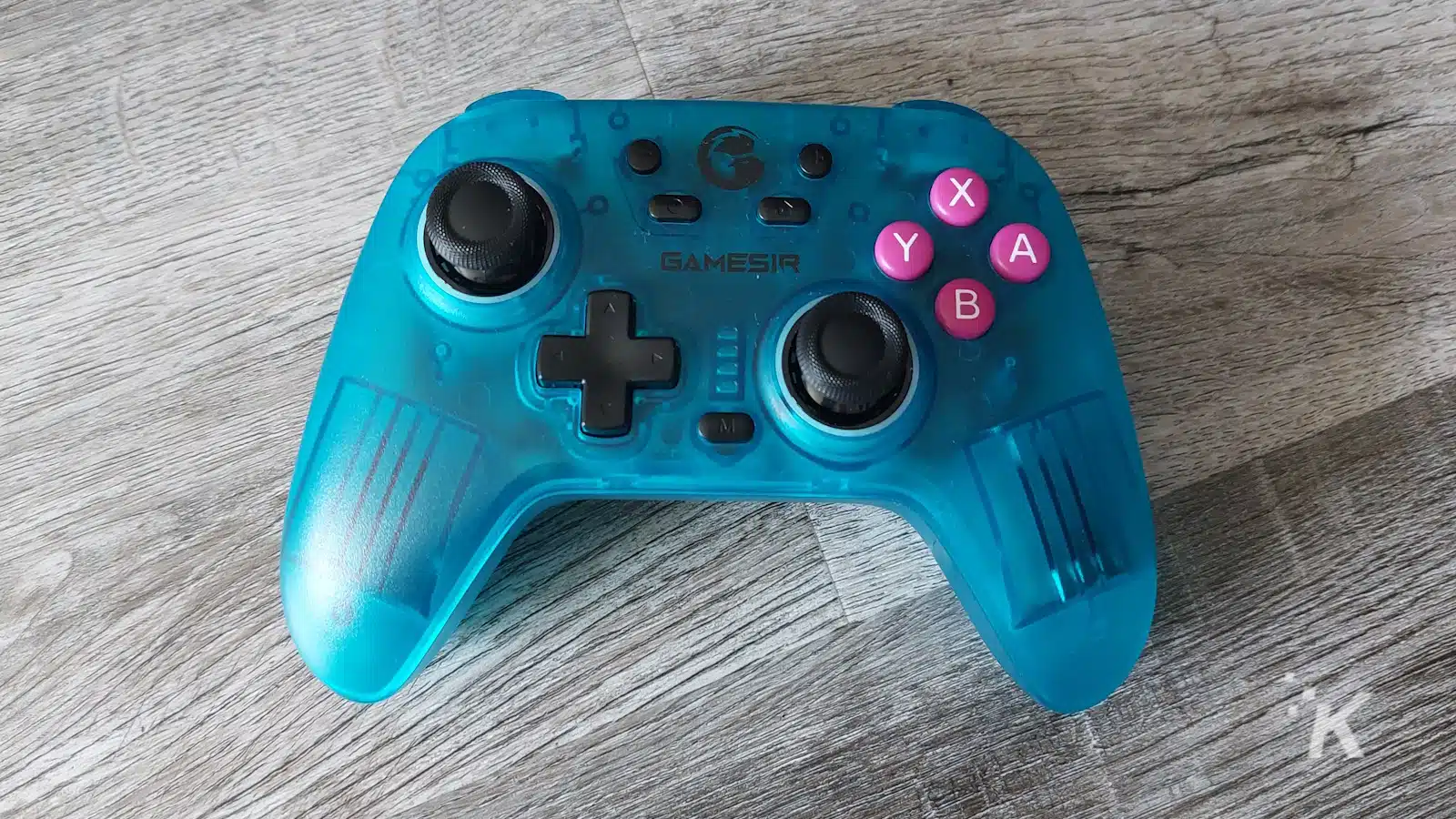 Controler de jocuri wireless Blue GameSir pe suprafață de lemn.