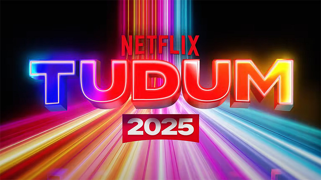 El logotipo de Netflix Tudum 2025 en colores brillantes que se sientan sobre un fondo negro y colorido